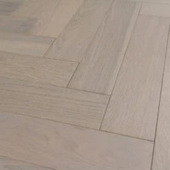Liberty Floors Pebble Grey Oak - Herringbone Parquet 14mm Engineered Real Wood Flooring (219386) -Famous Flooring Store pebble grey oak herringbone parquet 14mm engineered real wood flooring 219386 p85834 201394 image